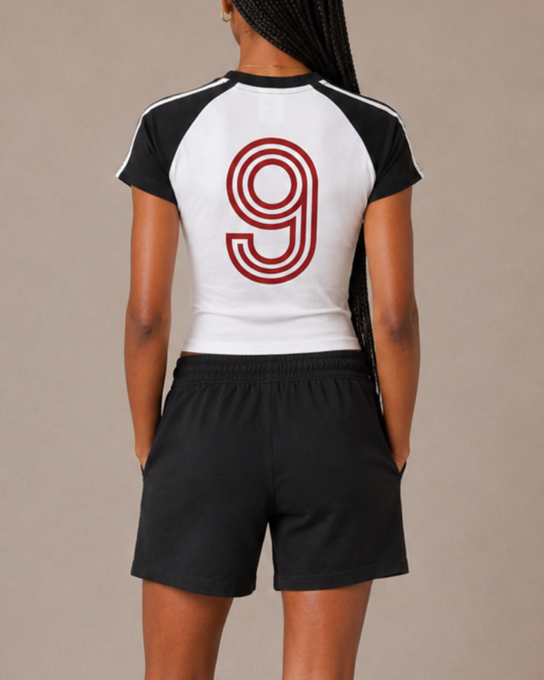Person wearing a sports outfit with number 9 on a beige background